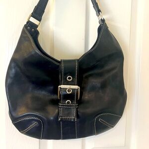 Michael Kors black hobo bag with white stitching and silver hardware.